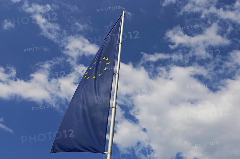 Flag of the European Union in front of a blue sky (Flag of the European Union in front of a blue blue sky)