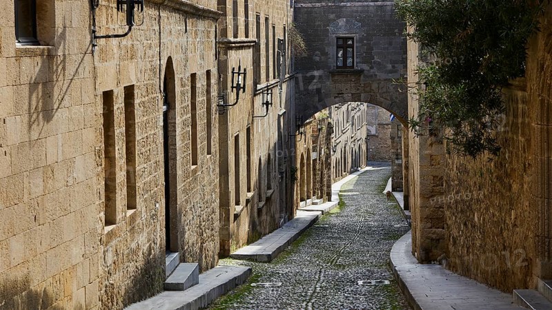Historic, narrow street with stone buildings and an arch, deserted, Knights' Street, Rhodes Old Town, Rhodes Town, Rhodes, Dodecanese, Greek Islands, Greece, Europe