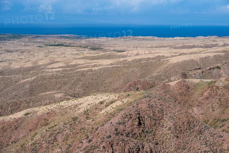 View of arid landscape and Issyk Kul Lake, Kyrgyzstan, Asia