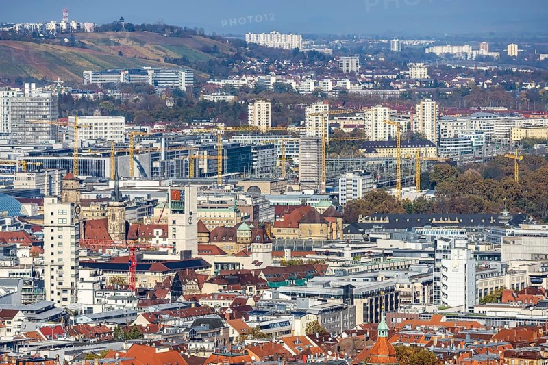 Central station with construction site Stuttgart 21, city centre with collegiate church, town hall tower, old castle and castle square. Behind it the new European quarter with modern office buildings. City view of Stuttgart Baden-Württemberg, Germany, Europe