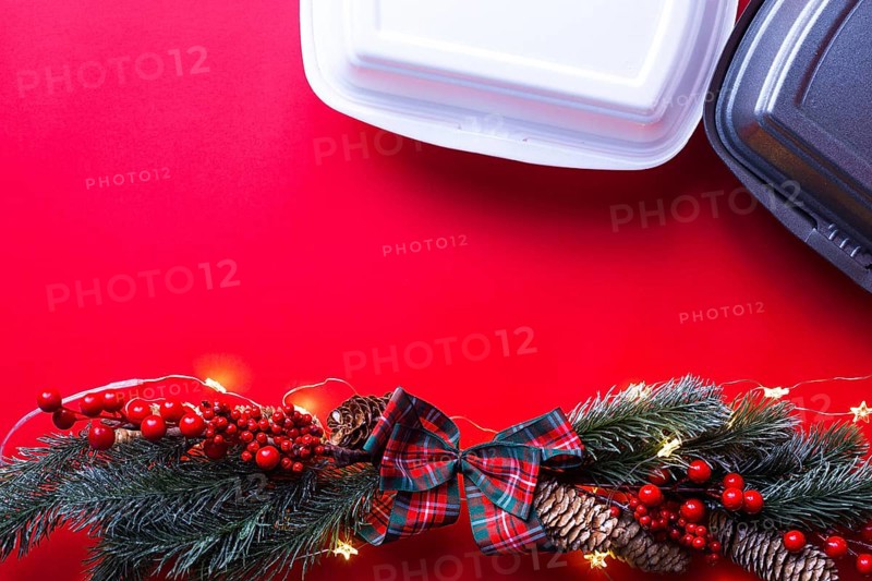 Christmas decor of food delivery service containers. New year's eve promotion. Ready-made hot order, disposable plastic and paper packaging. Work on public holidays catering. Copy space, mock up
