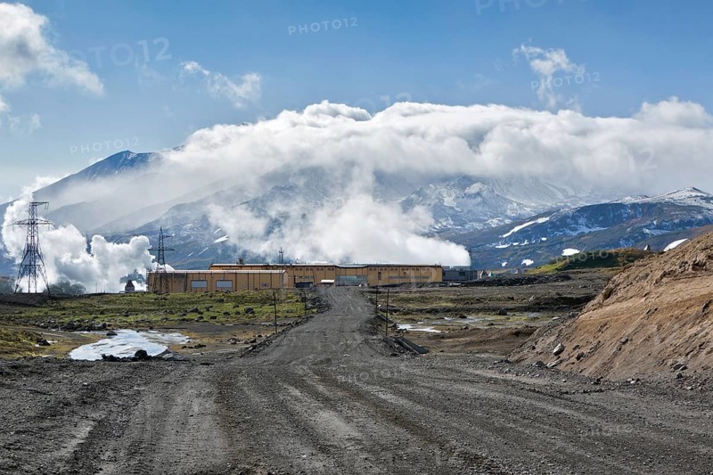 MUTNOVSKY VOLCANO, KAMCHATKA, RUSSIA, SEP 21, 2011: View of the road to Mutnovskaya Geothermal Power Station on background active Mutnovsky Volcano. Eurasia, Russia, Far East, Kamchatsky Krai, Europe