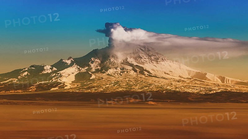 Winter volcanic landscape at sunrise, eruption crater active volcano on Kamchatka Peninsula. Effect of old film, vintage instant color photo effect, colorful picture with toned filter noise and grain