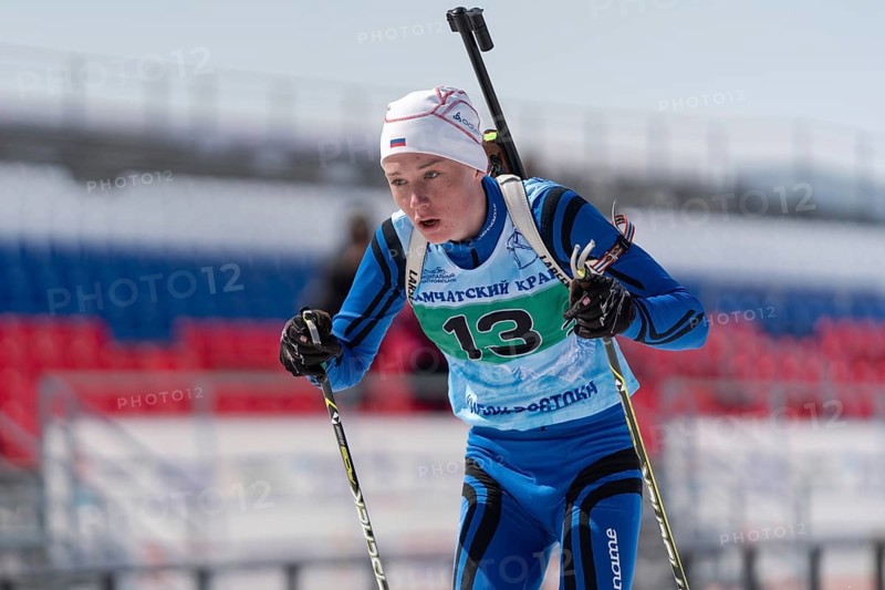 Sportsman biathlete Protasov Dmitry skiing on ski track distance biathlon stadium during Junior biathlon competitions East Cup. Petropavlovsk City, Kamchatka Peninsula, Russian Far East, Apr 14, 2019