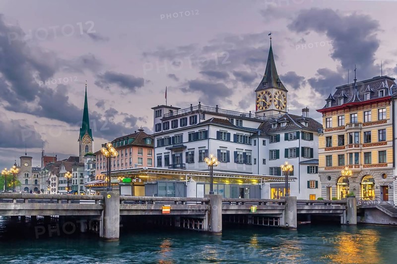 Embankment of Limmat river with view of St. Peter church in old town of Zurich, Switzerland, Europe