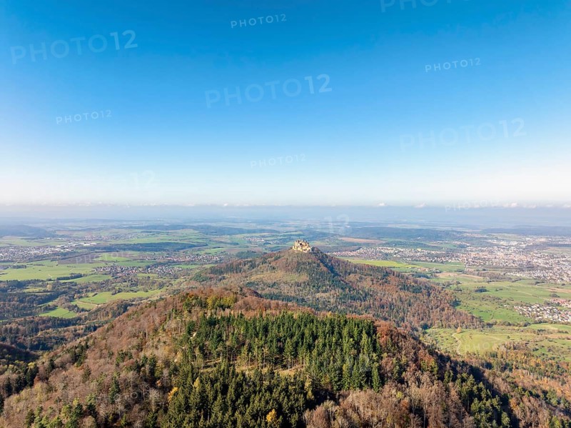 Aerial view from the Albtrauf over a mixed forest on the 956 metre high Raichberg to the Zeugenberg with Hohenzollern Castle, Zollernalbkreis, Baden-Württemberg, Germany, Europe