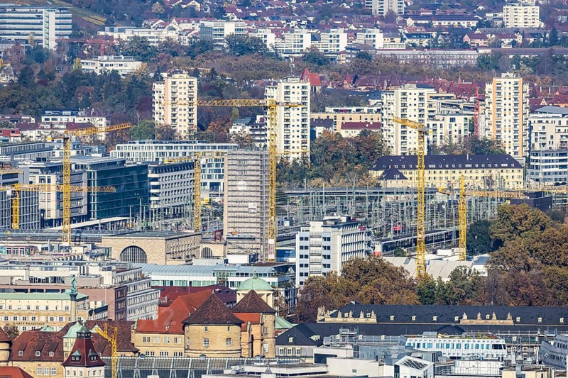 Central station with construction site Stuttgart 21, city centre with collegiate church, town hall tower, old castle and castle square. Behind it the new European quarter with modern office buildings. City view of Stuttgart Baden-Württemberg, Germany, Europe