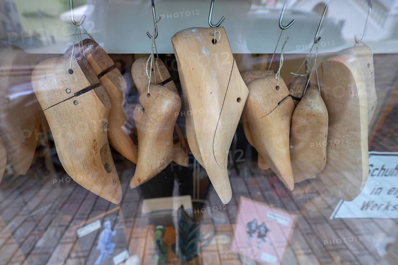 Shoe lasts on hooks in the window of a shoemaker's shop, Iphofen, Lower Franconia, Bavaria, Germany, Europe