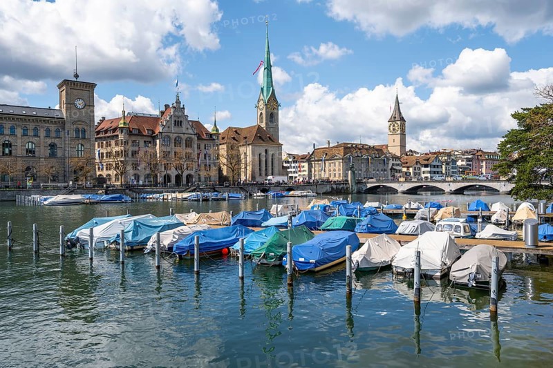 Boats at the jetty in the river Limmat, towers of Fraumünster and St Peter, Old Town, Zurich, Switzerland, Europe