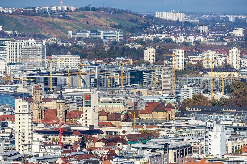 Central station with construction site Stuttgart 21, city centre with collegiate church, town hall tower, old castle and castle square. Behind it the new European quarter with modern office buildings. City view of Stuttgart Baden-Württemberg, Germany, Europe