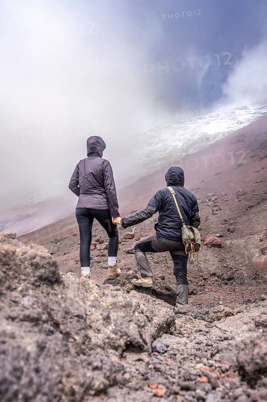Couple standing in front of the Cotopaxi, Cotopaxi, Cotopaxi National Park, Latacunga, Ecuador, South America