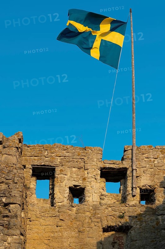 Old city wall with flag or banner of Sweden, former Hanseatic city of Visby, UNESCO World Heritage Site, Gotland Island, Sweden, Europe