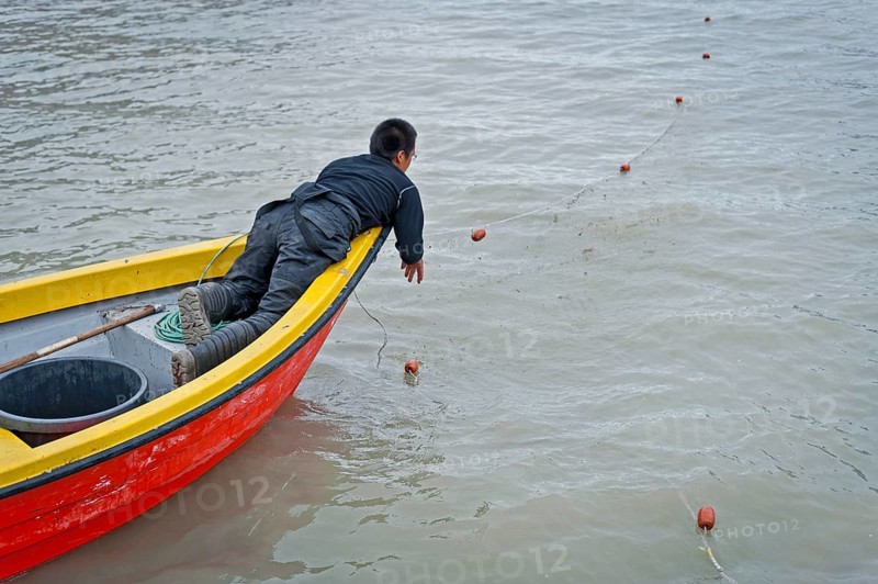 Inuit hunter sets a net, near the Inuit settlement Tiniteqilaaq or Greenlandic Tiilerilaaq, Sermilik Fjord, East Greenland, Greenland, North America