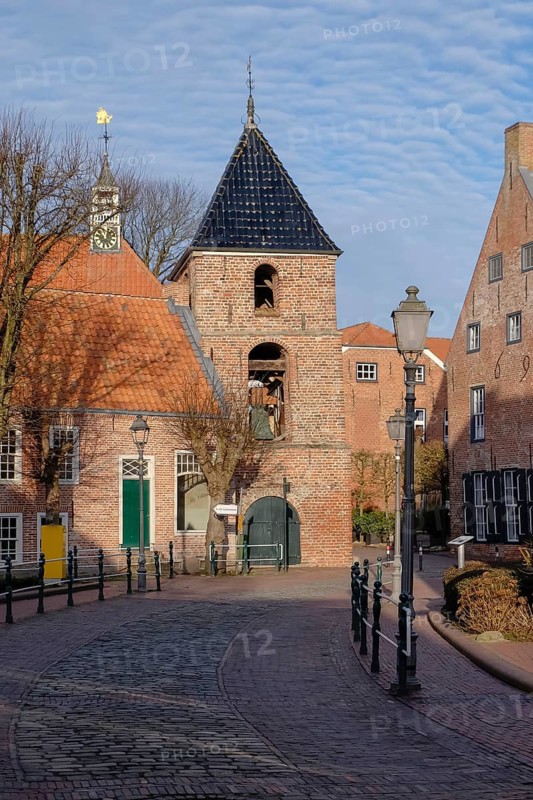 Alley in Greetsiel with a view of the bell tower of the Protestant Reformed Church, Greetsiel, Krummhörn, East Frisia, Lower Saxony, Germany, Europe