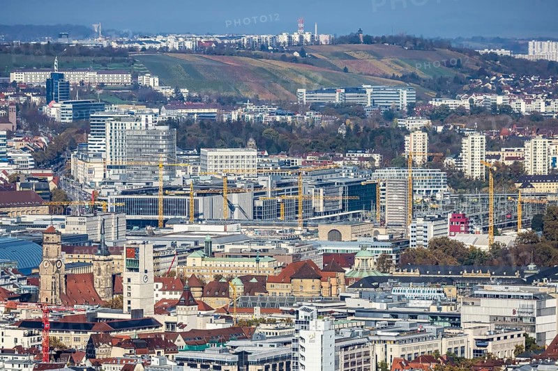 Central station with construction site Stuttgart 21, city centre with collegiate church, town hall tower, old castle and castle square. Behind it the new European quarter with modern office buildings. City view of Stuttgart Baden-Württemberg, Germany, Europe