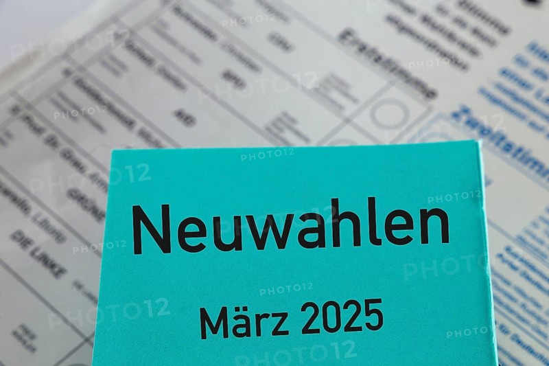 Symbolic image of new elections in Germany: Paper with the inscription NEUWAHLEN MÄRZ 2025 in front of a ballot paper