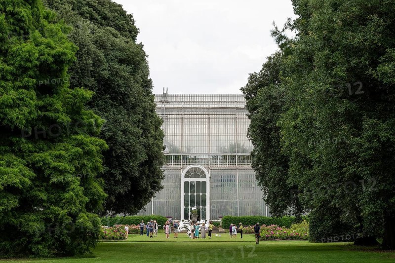 Visitors in front of the Palm House, the oldest Victorian greenhouse in the world, Royal Botanic Gardens, Kew, London, England, Great Britain