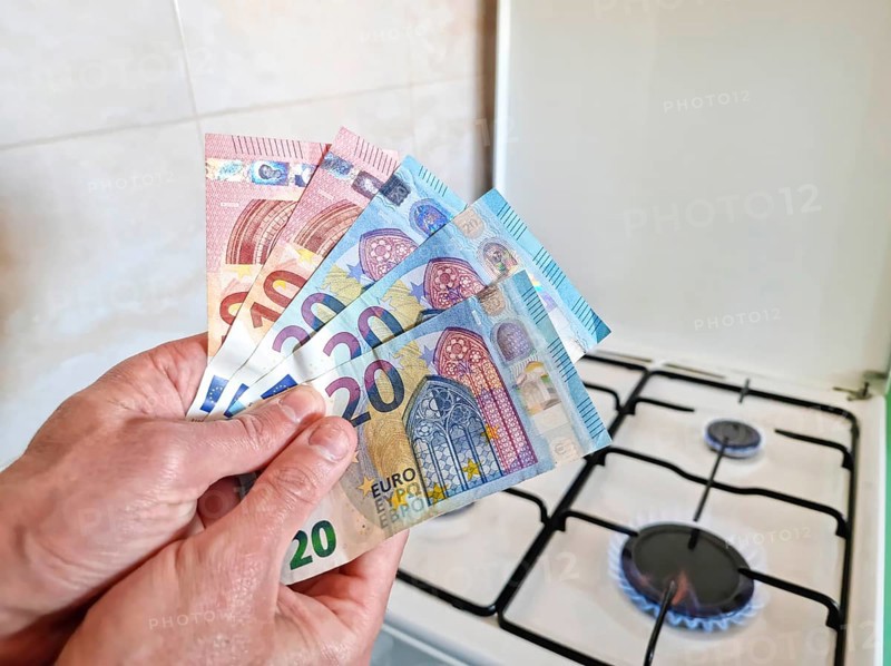 Energy efficiency concept with gas cooker and euro currency – the cost of natural gas is more expensive. Selective focus