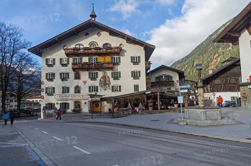 MAYRHOFEN, AUSTRIA, MARCH 5, 2017: Decorated in the traditional Tyrolean style facade of the hotel. Mayrhofen, ski resort town in Austrian Alps. March, a sunny day