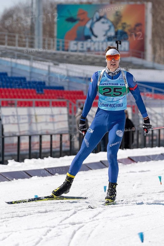 Kamchatka sportsman biathlete Ageev Danil in action skiing on ski track distance biathlon arena. Junior biathlon competitions East Cup. Petropavlovsk City, Kamchatka Peninsula, Russia, April 14, 2019, Europe