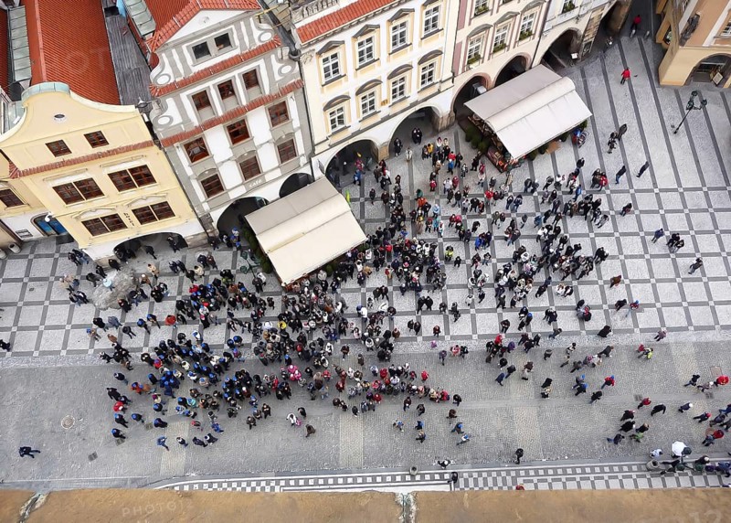 PRAGUE, CZECH REPUBLIC, MARCH 13 2009: Group of tourists at the historical centre of Prague and traditional architectural buildings below the famous astronomical clock in Prague, Czech Europe