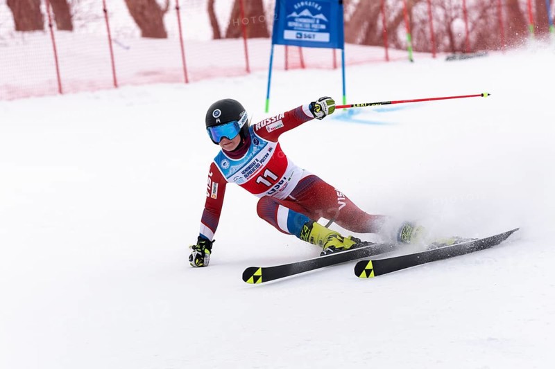 KAMCHATKA PENINSULA, RUSSIA, APRIL 2, 2019: Mountain skier Sofya Krokhina Moscow skiing down mount slope. Russian Women s Alpine Skiing Cup, International Ski Federation Championship, giant slalom