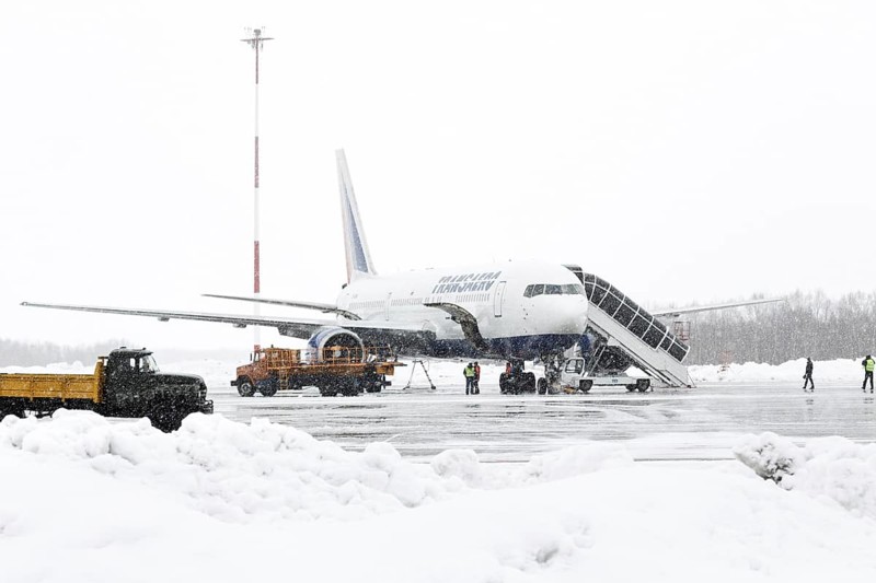 PETROPAVLOVSK-KAMCHATSKY, KAMCHATKA, RUSSIA, MARCH 19, 2015: Service and technical support airfield maintenance airplane Boeing-767 Transaero Airlines at airport of Petropavlovsk-Kamchatsky (Elizovo airport) at the time of bad weather (snowfall)