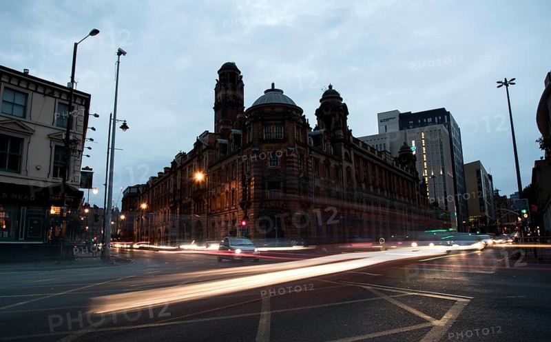 Manchester, United Kingdom, September 24 2016: Light trails of cars and buses moving with speed at Piccadilly avenue near the main train station in the city of Manchester in England, Europe