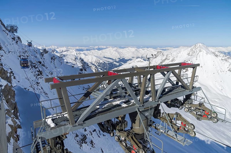 Cable car masts on a steep slope. Austrian Alps. The top of the Hintertux Glacier, 3250 meters above sea level