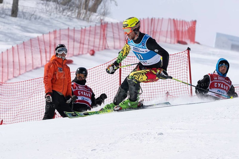 MOROZNAYA MOUNTAIN, KAMCHATKA PENINSULA, RUSSIA, MARCH 29, 2019: Mountain skier Breitfuss Kammerlander Simon Bolivia skiing down mount slope. International Ski Federation FIS Championship, slalom