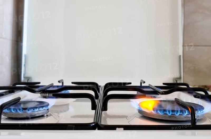 Energy efficiency concept with gas cooker – the cost of natural gas is more expensive. Close up, selective focus