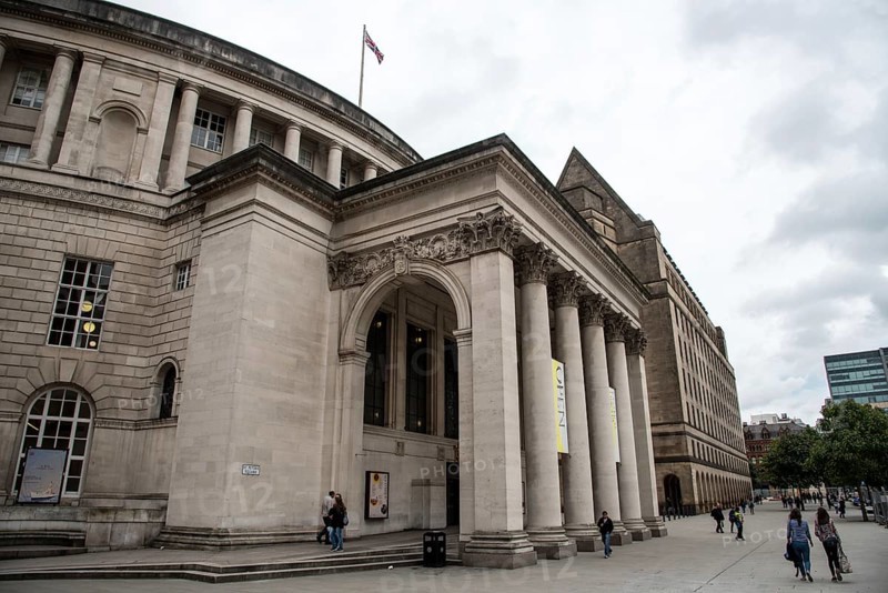 Manchester, England, September24, 2016: Exterior view of the curved building of the central library of Manchester in UK with people walking on the St Peters Square