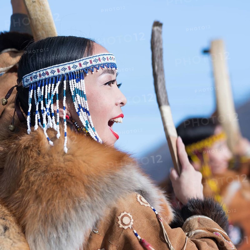 Female dancing with tambourine in tradition clothing aboriginal people of Kamchatka. Concert celebration Koryak national ritual holiday Hololo, Day of Seal. Kamchatka Peninsula, Russia, Nov 4, 2018, Europe