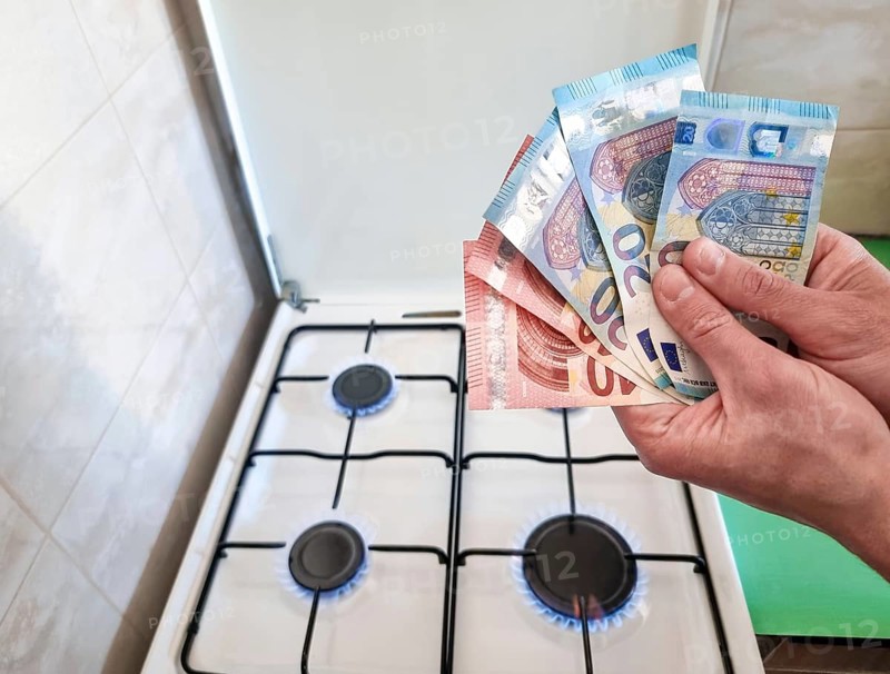 Energy efficiency concept with gas cooker and euro currency – the cost of natural gas is more expensive. Selective focus