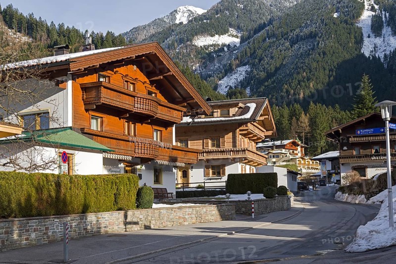 Modern houses in the ski resort of Mayrhofen, built in the traditional Tyrolean style. Tyrol, Austria. Sunny day in March