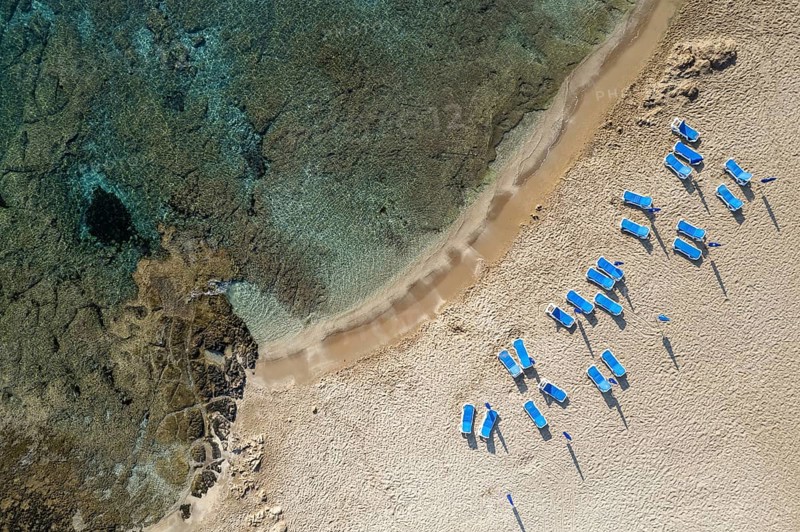 Drone aerial of beach umbrellas in the beach. Summer holidays in the sea. Paphos Cyprus Europe