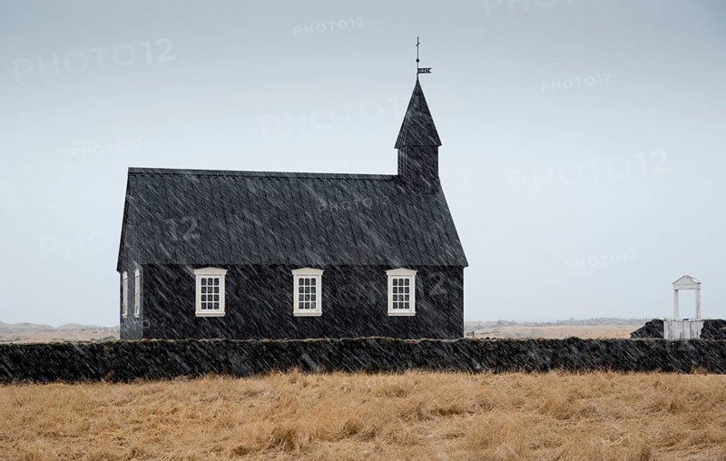 Famous picturesque black church of Budir at Snaefellsnes peninsula region in Iceland during a heavy snowy weather
