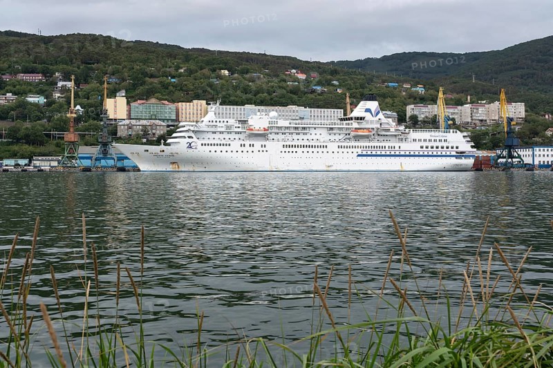 AVACHA BAY, KAMCHATKA PENINSULA, RUSSIAN FAR EAST, 4 SEPTEMBER, 2018: Evening view of white Japanese cruise liner Pacific Venus anchored at marine station in Sea Port of Petropavlovsk-Kamchatsky City