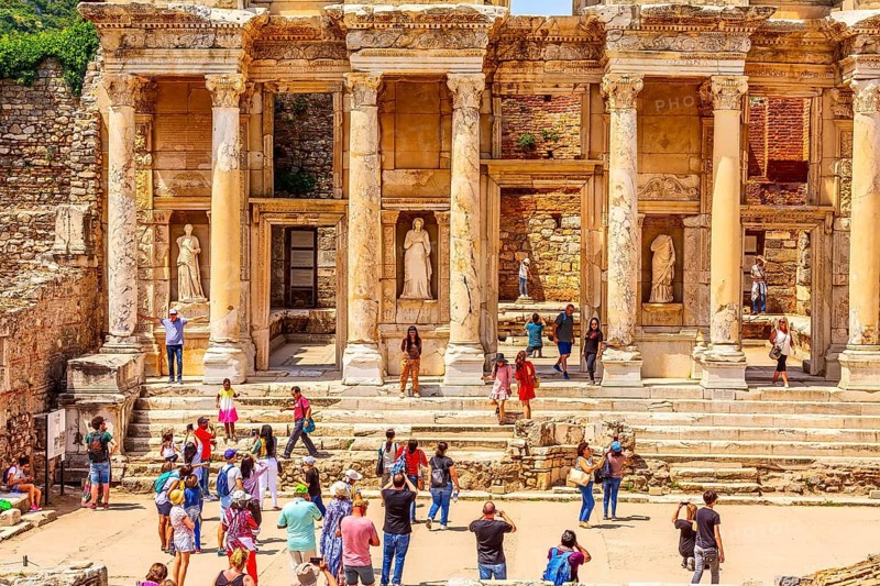 Kusadasi, Turkey, April 28, 2019: People visiting Celsus Library and old ruins of Ephesus or Efes famous site, Asia