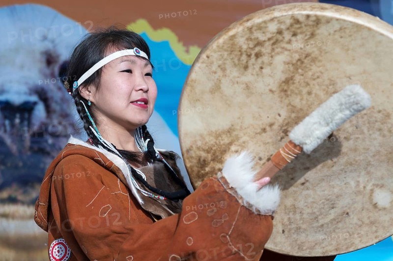 Woman dancing with tambourine in tradition clothing aborigine people Kamchatka. Concert, celebration Koryak national holiday Hololo Day of Seal. Kamchatka Region, Russia, November 4, 2018, Europe