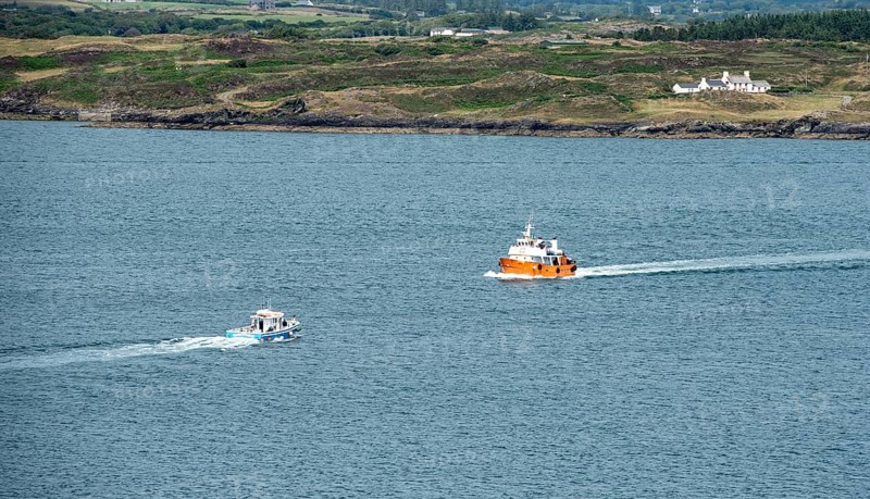 Small fishing boat sailing in Atlantic sea. Leisure activity, for whale watching, sport and recreation. Baltimore Cork Ireland