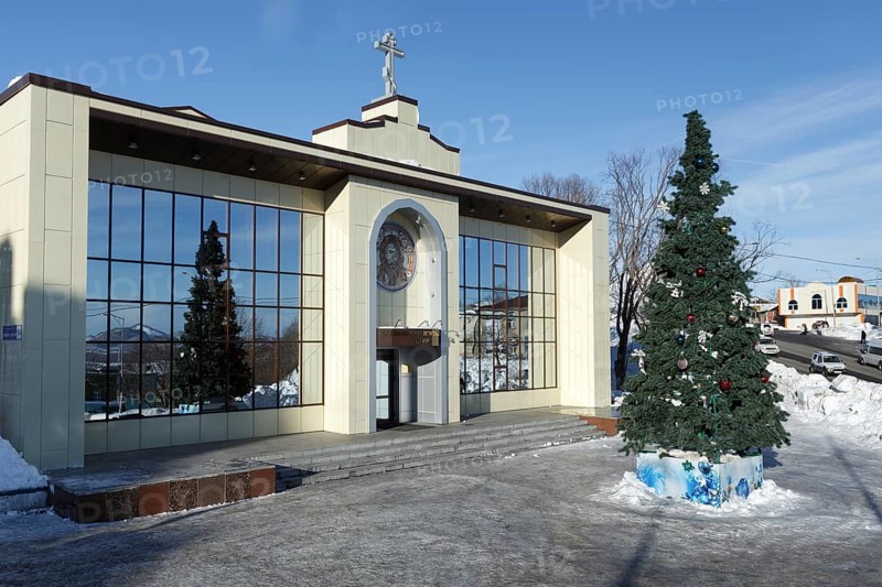 PETROPAVLOVSK CITY, KAMCHATKA, RUSSIA, JAN 6, 2018: Diocesan Spiritual and Enlightenment Center of Petropavlovsk, Kamchatka Diocese of Russian Orthodox Church and Christmas tree in front of building