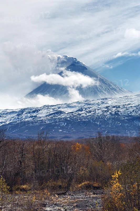 Volcanic landscape of Kamchatka: active Klyuchevskaya Sopka, view of volcanic eruption, plume of gas, steam and ash from crater. Kamchatka Peninsula, Russian Far East, Klyuchevskaya Group of Volcanoes