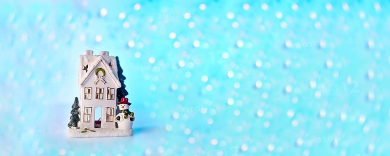 Christmas or New Year snow house decoration, snowman, blue bokeh background with lights banner