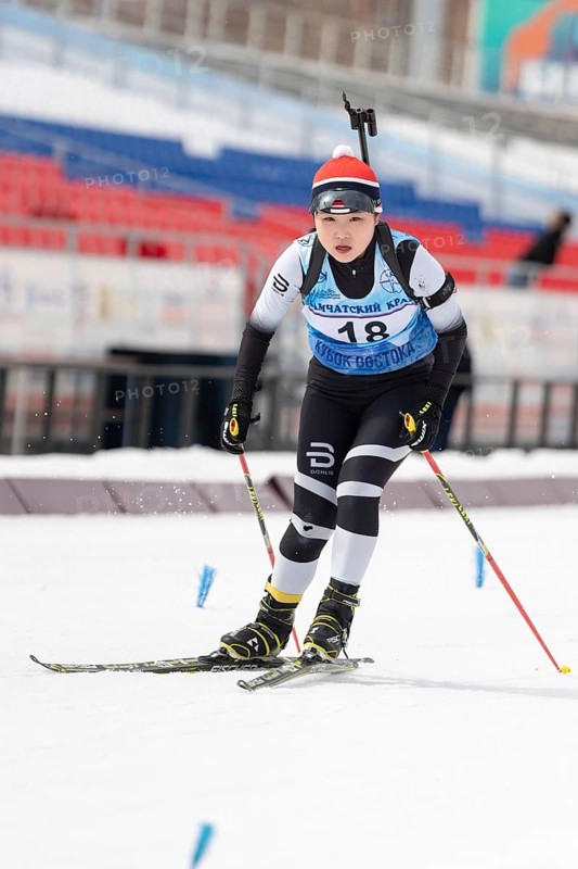 Korean biathlete sportswoman Choi Yoonah Korea skiing on distance biathlon complex during Open regional youth biathlon competitions East Cup. Kamchatka Peninsula, Russian Far East, April 12, 2019