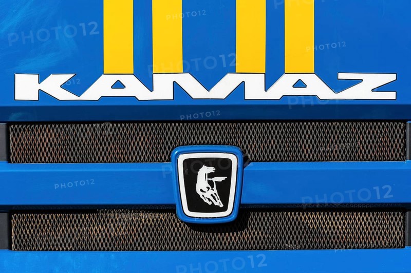 KAMCHATKA, RUSSIA, OCT 2, 2018: Badge and logotype of truck KAMAZ and sticker orange-blue stripes of Emercom of Russia on front car cabin. KAMAZ, Russian brand of engines manufacturer and trucks