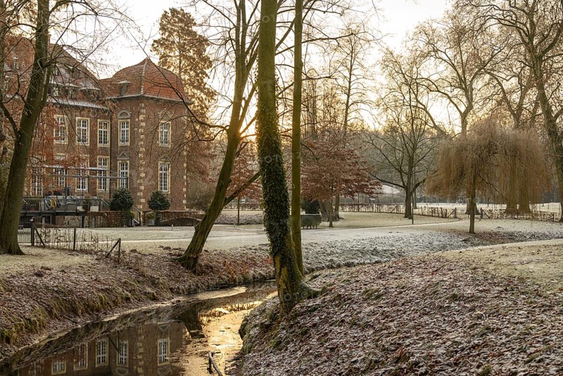 Winter river landscape at sunset with historic building, Velen, North Rhine-Westphalia, Germany, Europe