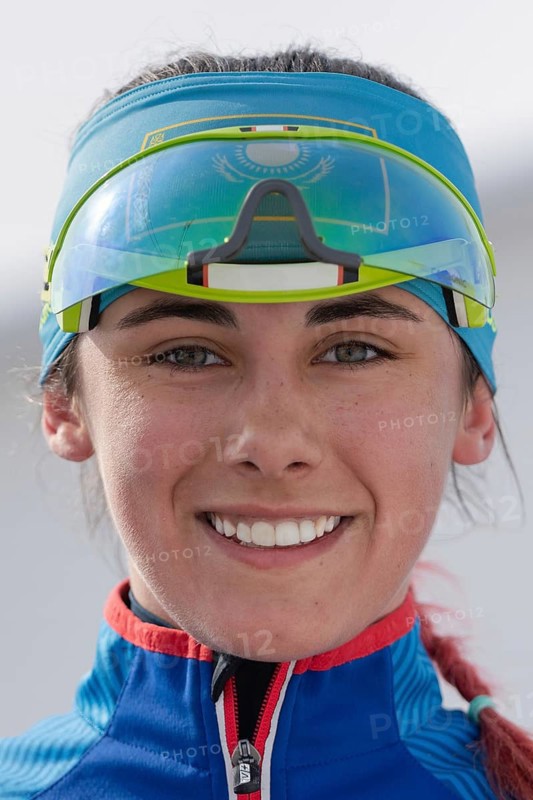 Portrait of smiling sportswoman biathlete Polina Yegorova Kazakhstan at finish after rifle shooting and skiing. Regional junior biathlon competitions East of Cup. Kamchatka, Russia, April 13, 2019, Europe