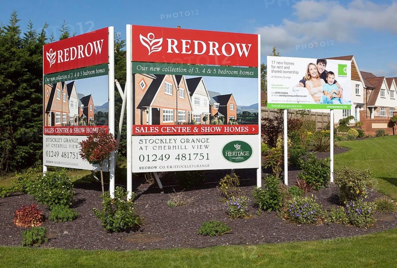 Redrow advertising poster signs for new housing for sale at Cherhill View, Stockley Grange, near Calne, Wiltshire, England, UK