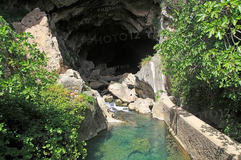 Person exploring entrance ot cave, Cueva del Gato, Benaojan, Serrania de Ronda, Malaga province, Spain, Europe